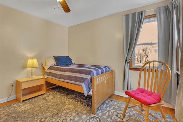 bedroom with ceiling fan and wood-type flooring