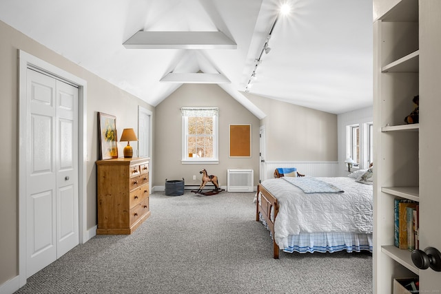 carpeted bedroom with lofted ceiling with beams and track lighting