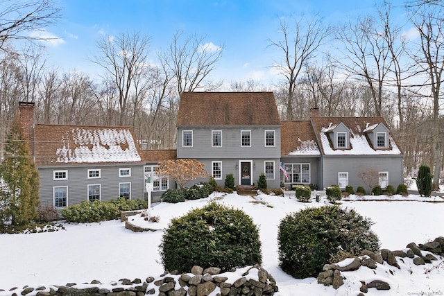 colonial-style house with a chimney