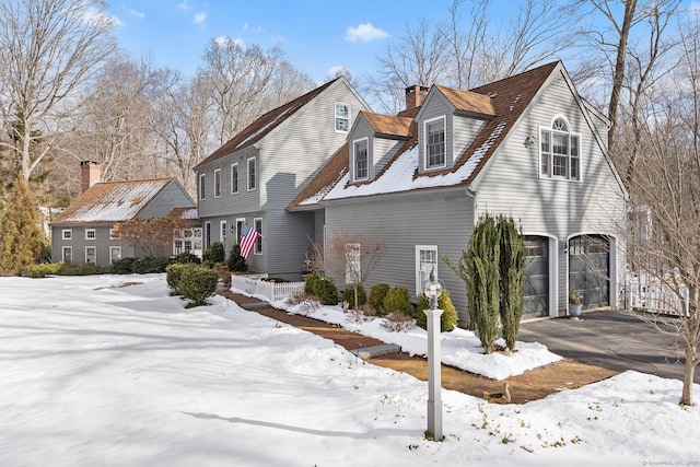 view of front of property with a garage and a chimney