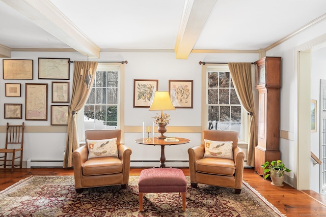 living area with crown molding, a baseboard heating unit, beam ceiling, and wood finished floors