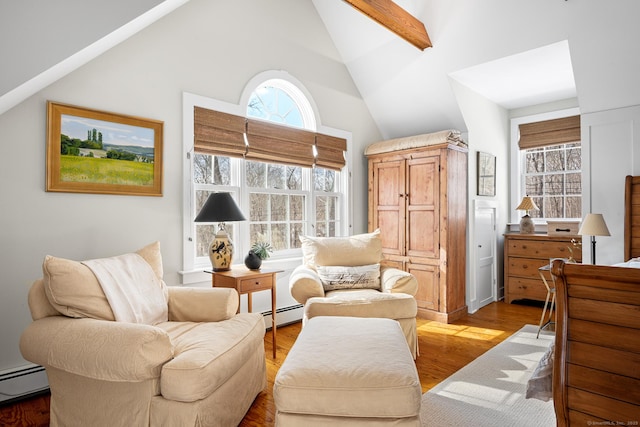 living area featuring light wood-type flooring, high vaulted ceiling, a baseboard radiator, and a baseboard heating unit