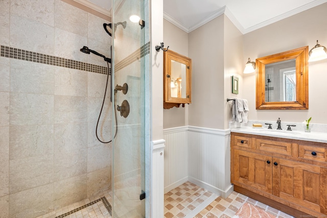 full bath featuring ornamental molding, wainscoting, a tile shower, and vanity