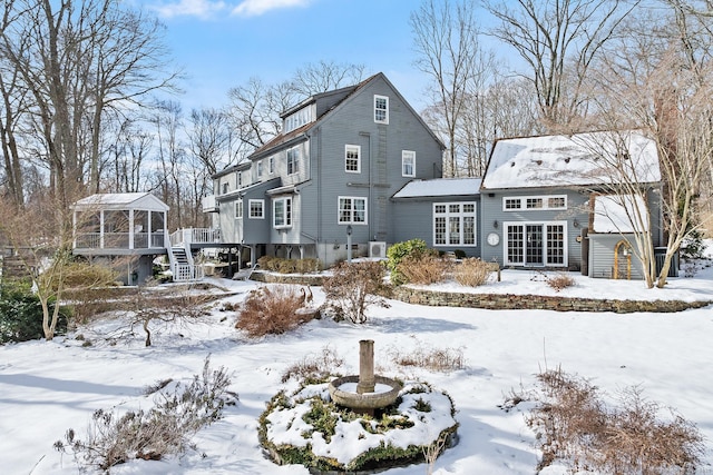 view of snow covered rear of property