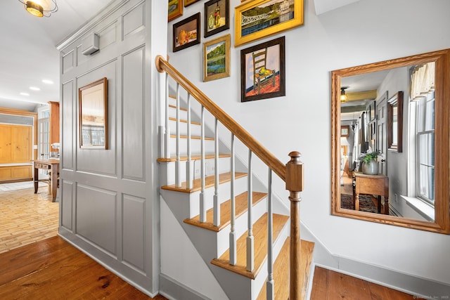 stairs with recessed lighting, baseboards, and wood finished floors