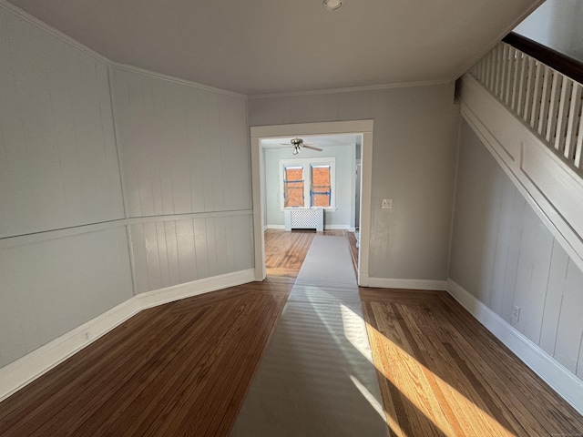 interior space with ornamental molding and dark hardwood / wood-style floors