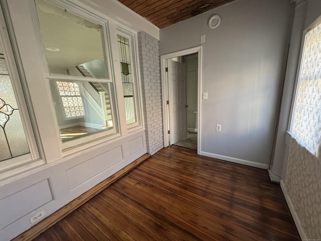 spare room featuring dark wood-type flooring