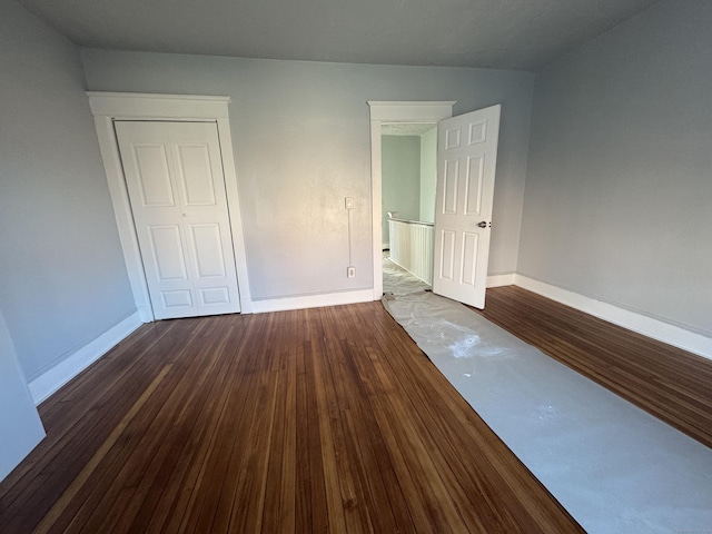 spare room with dark hardwood / wood-style flooring