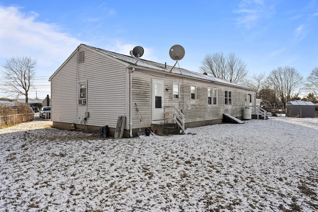 view of snow covered rear of property