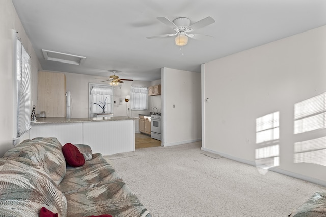 carpeted living room featuring ceiling fan