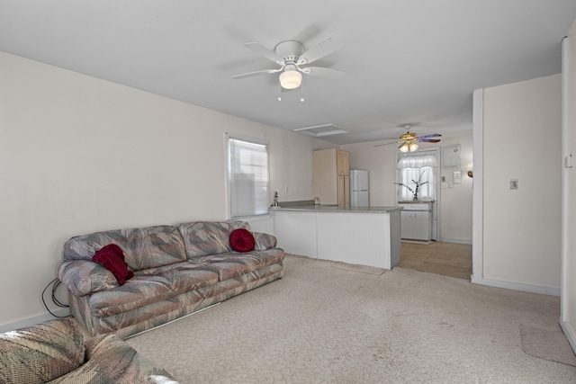 carpeted living room featuring ceiling fan