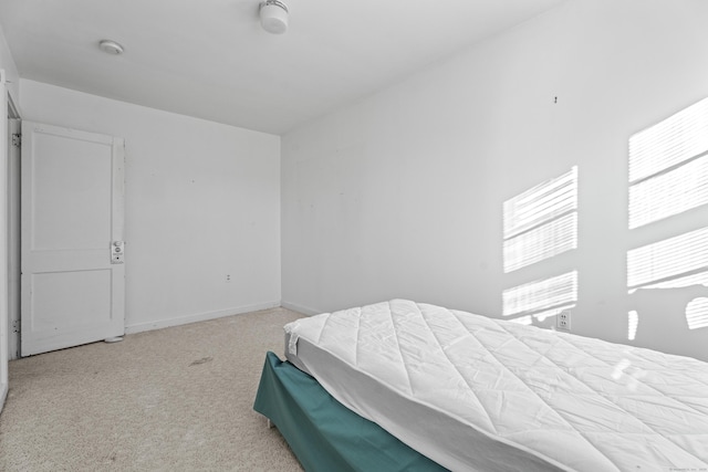 bedroom with light colored carpet