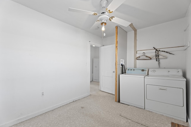 clothes washing area featuring washing machine and dryer, light colored carpet, and ceiling fan