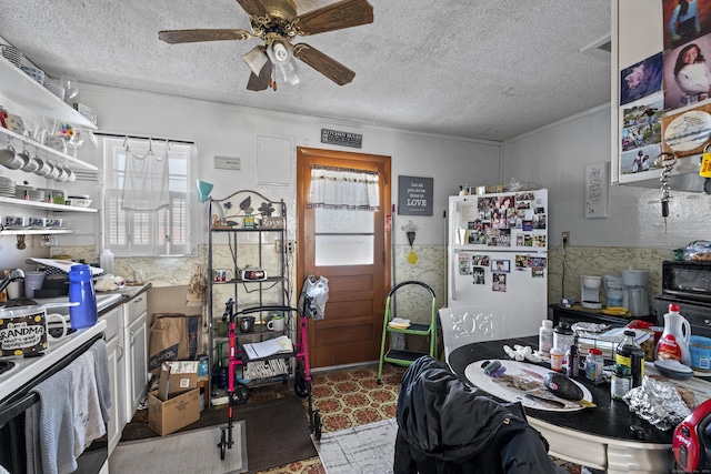 kitchen featuring ceiling fan, a textured ceiling, and white fridge