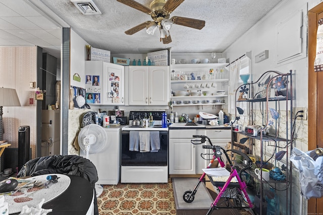 kitchen with sink, a textured ceiling, electric stove, ceiling fan, and white cabinets