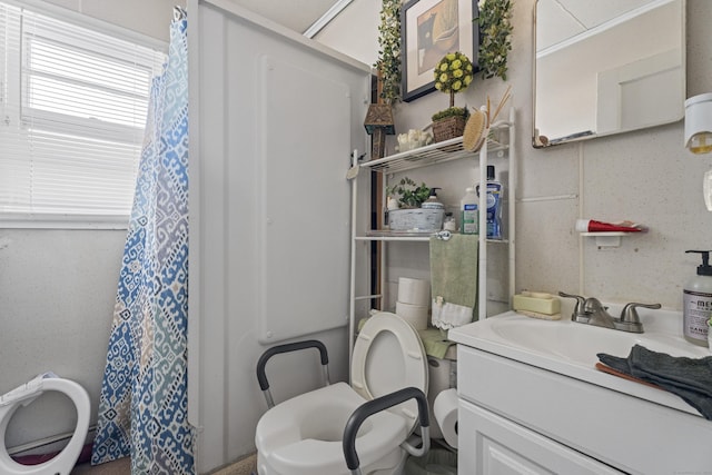 bathroom featuring vanity and toilet