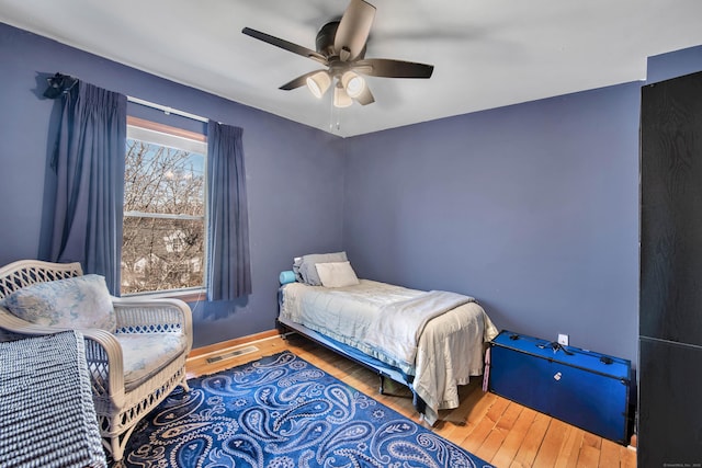 bedroom with ceiling fan and hardwood / wood-style floors