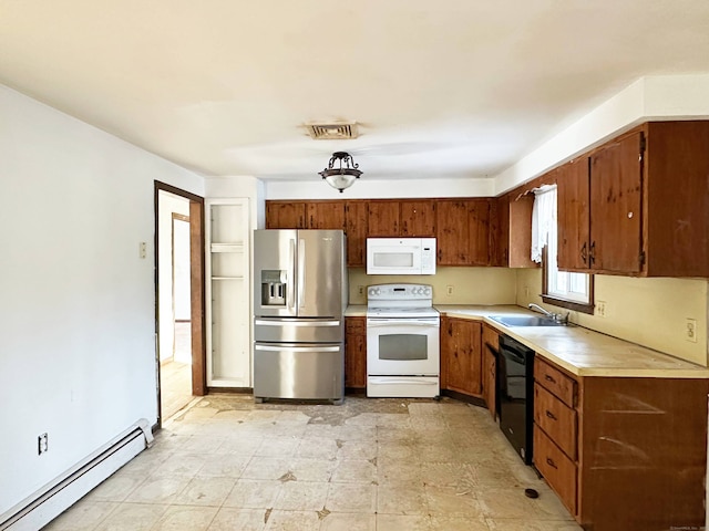 kitchen with white appliances, visible vents, baseboard heating, light countertops, and a sink