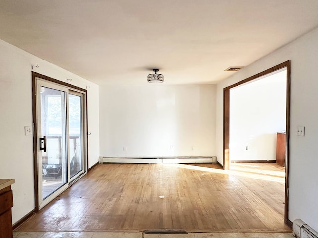 unfurnished room with light wood-style flooring, baseboards, and baseboard heating