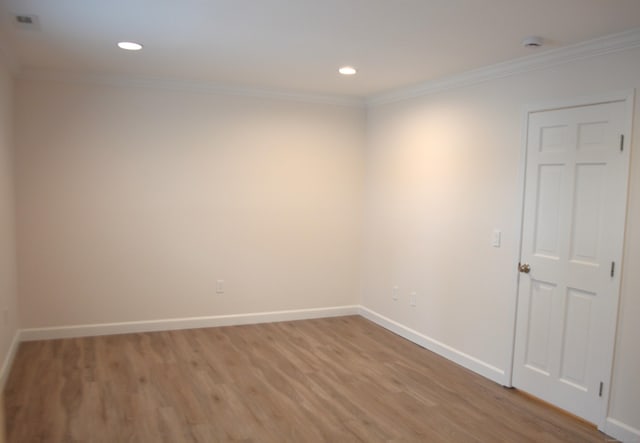 unfurnished room featuring hardwood / wood-style floors and ornamental molding