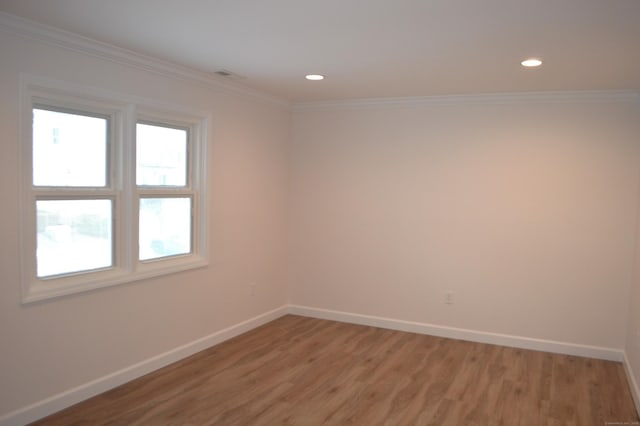 unfurnished room featuring crown molding and wood-type flooring