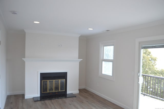 unfurnished living room featuring crown molding and light wood-type flooring