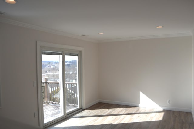 unfurnished room with crown molding and wood-type flooring