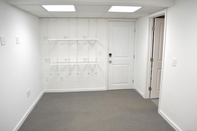 carpeted spare room with a paneled ceiling