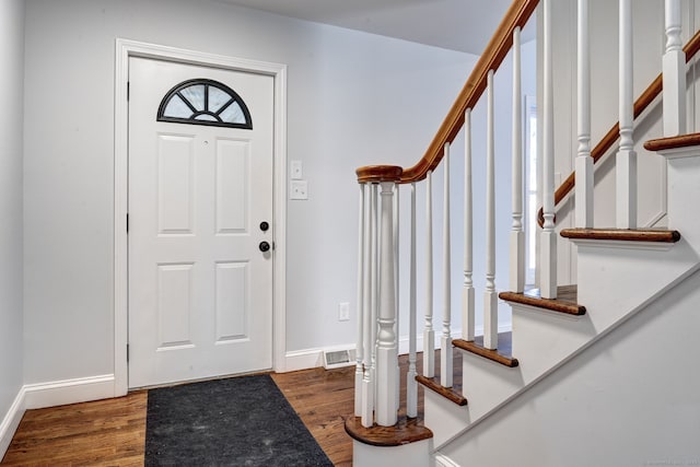 foyer entrance featuring dark wood-type flooring