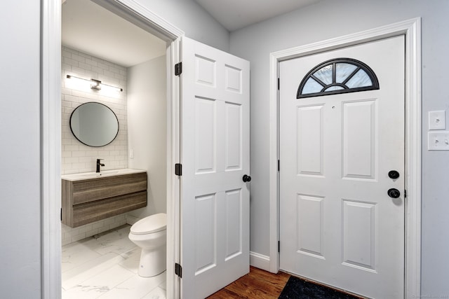 bathroom featuring vanity, backsplash, and toilet