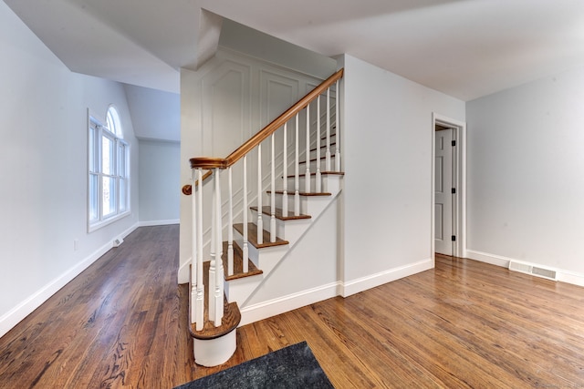 staircase featuring hardwood / wood-style floors