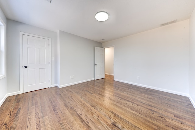 empty room featuring wood-type flooring