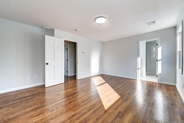 empty room with dark hardwood / wood-style floors