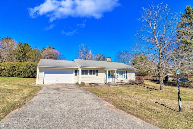 ranch-style house with a garage and a front lawn