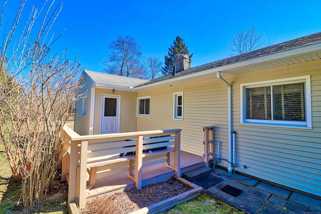 back of house featuring a wooden deck