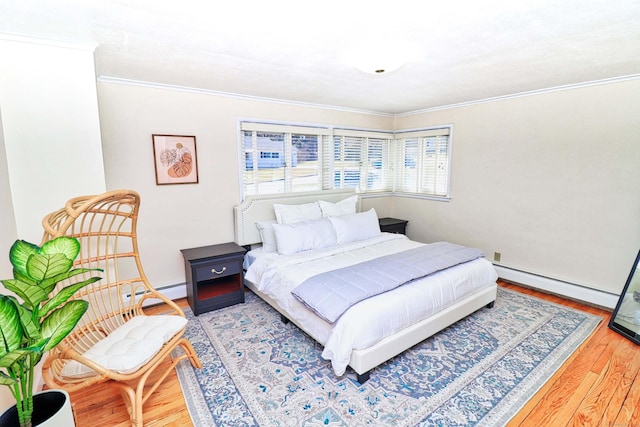 bedroom featuring a baseboard radiator, ornamental molding, and hardwood / wood-style floors