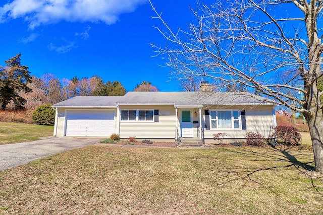 ranch-style house with a garage and a front lawn