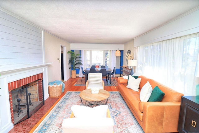 living room with hardwood / wood-style floors, a fireplace, and a textured ceiling