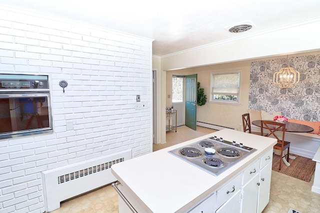 kitchen with white cabinetry, a baseboard heating unit, radiator heating unit, wall oven, and cooktop