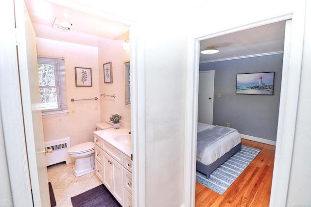 bathroom with vanity, radiator heating unit, tile patterned floors, and toilet