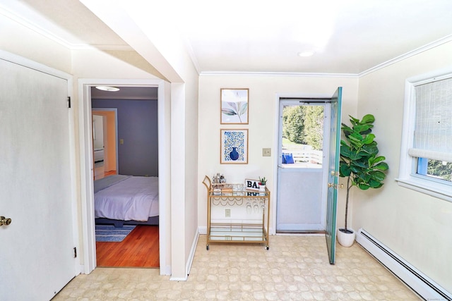 doorway with crown molding, a wealth of natural light, and baseboard heating