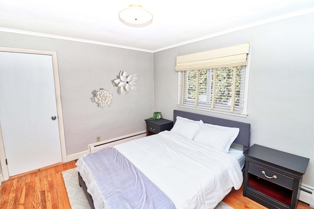 bedroom with a baseboard radiator, ornamental molding, and light wood-type flooring