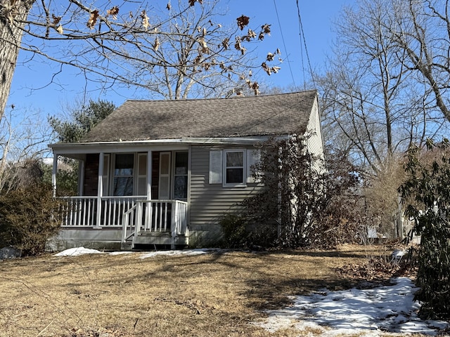 view of front facade featuring a porch and a shingled roof