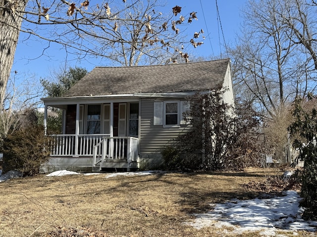 view of front of house with covered porch and roof with shingles