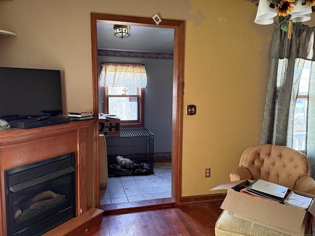 office area featuring a fireplace, wood finished floors, and baseboards