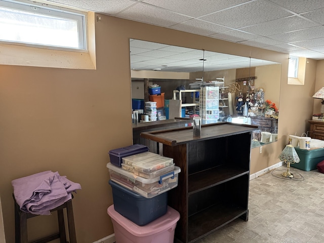 kitchen with baseboards and a drop ceiling