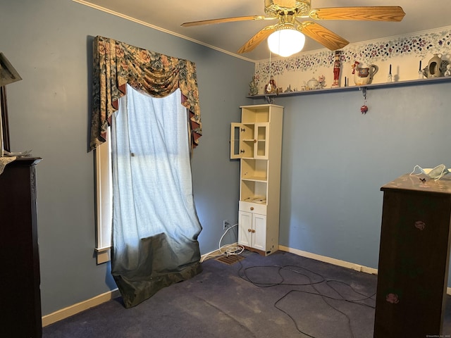 unfurnished bedroom featuring ornamental molding, carpet, baseboards, and a ceiling fan