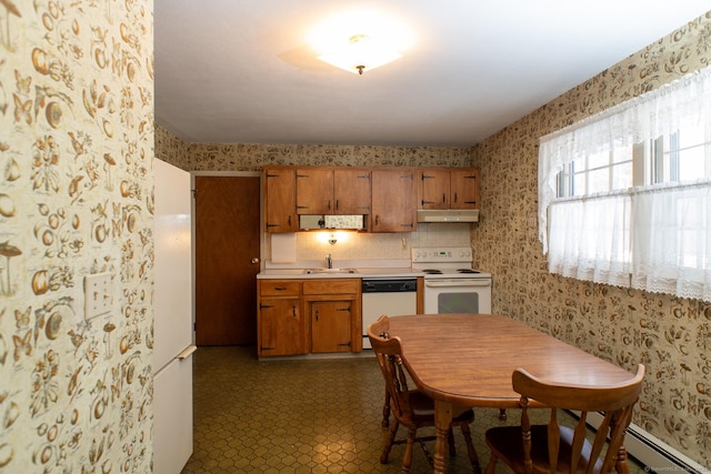 kitchen featuring white appliances, light countertops, and wallpapered walls