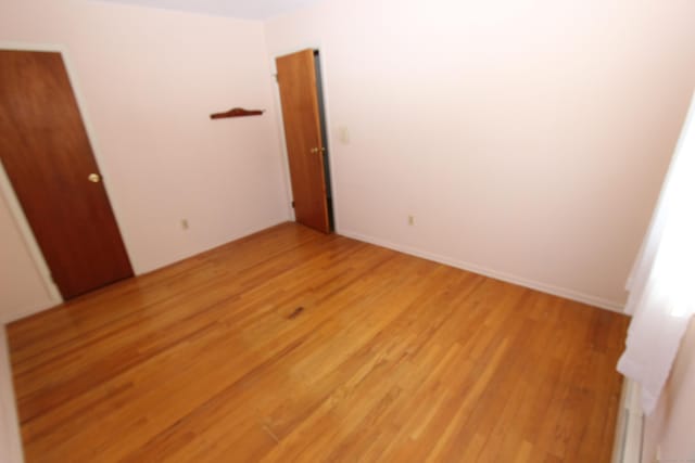 unfurnished bedroom with light wood finished floors