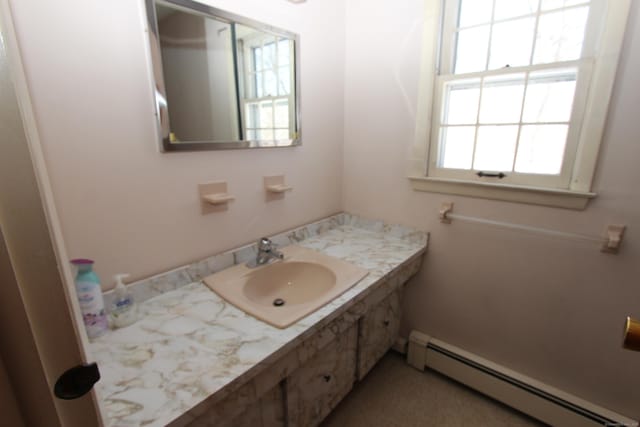 bathroom with vanity and baseboard heating